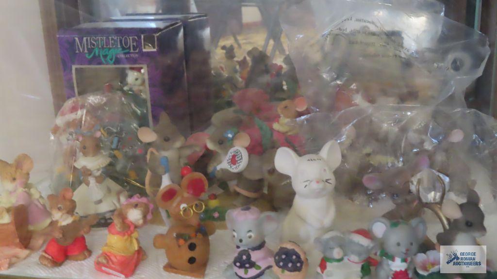 two shelves of mice figurines