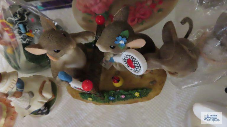 two shelves of mice figurines