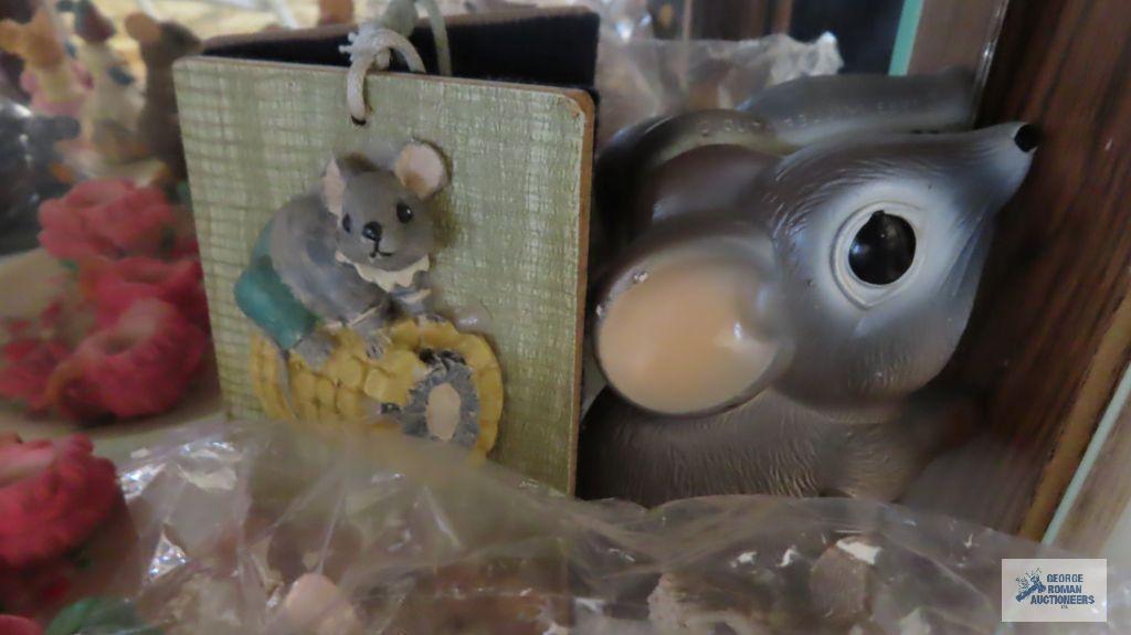 two shelves of mice figurines