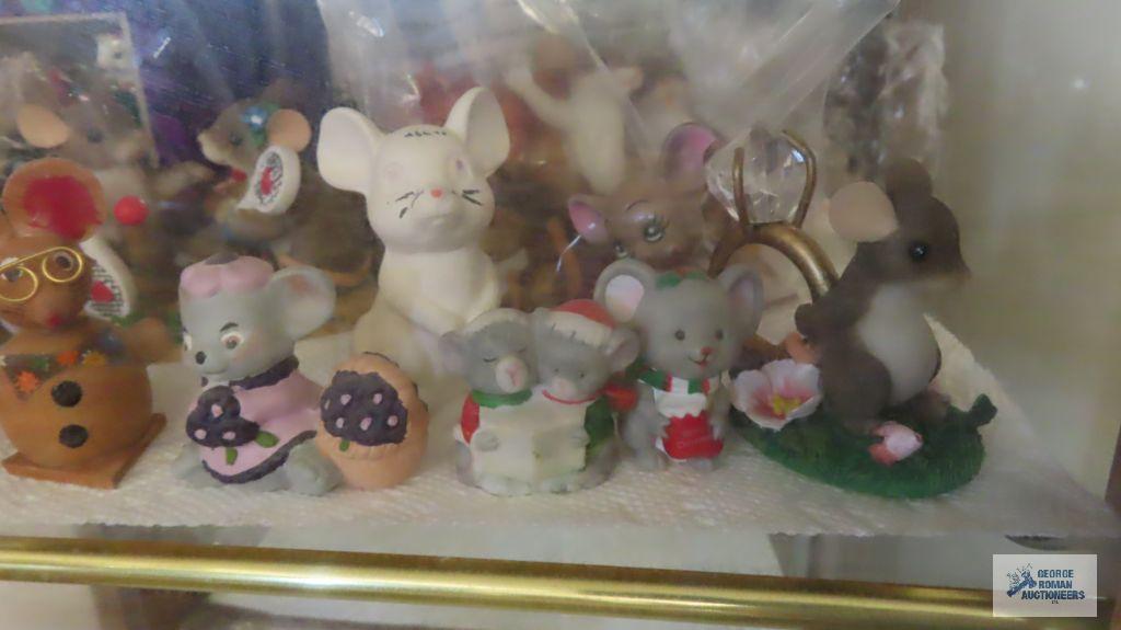 two shelves of mice figurines