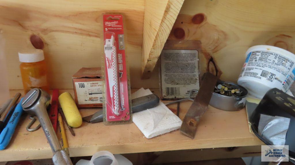 lot of hand tools, solvents, and etc on bench