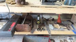 vintage braces, bottle jacks, vintage wooden level, etc under bench