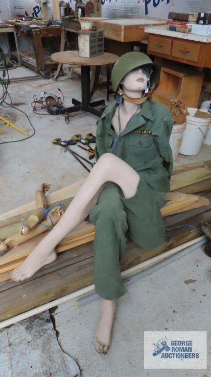 lot of mannequin parts and military clothing with helmet