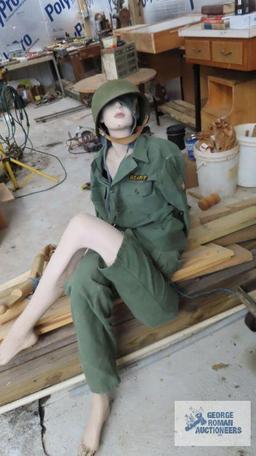 lot of mannequin parts and military clothing with helmet