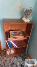 bookshelf, pictures frames, photo albums and table fan
