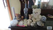 miscellaneous items including teddy bear, religious items, alarm clock