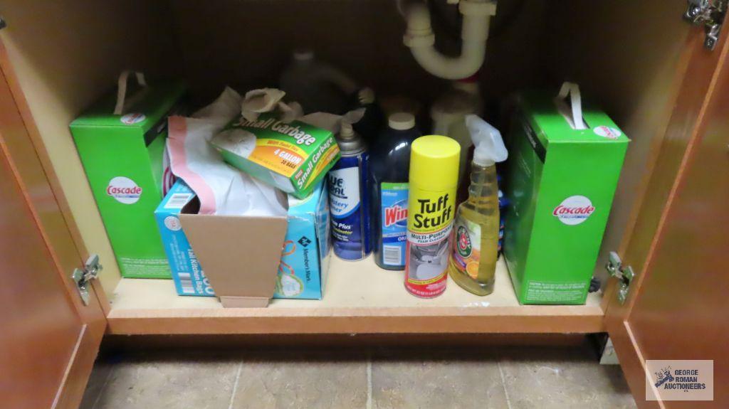 Lot of cleaning supplies under sink