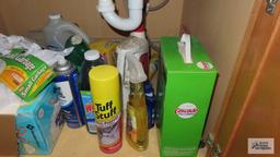 Lot of cleaning supplies under sink