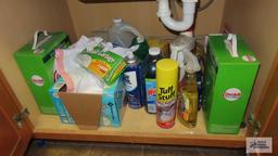 Lot of cleaning supplies under sink