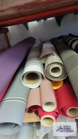 Rolls of fabric on middle shelf