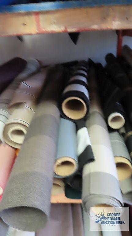 Rolls of fabric on middle shelf