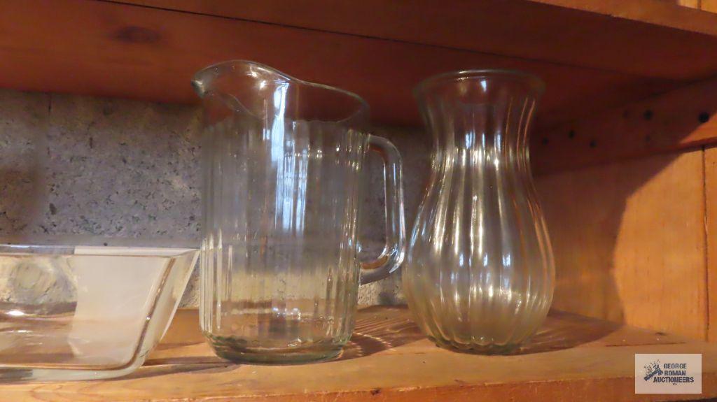 Lot of clear glassware including vases, pitchers, and etc