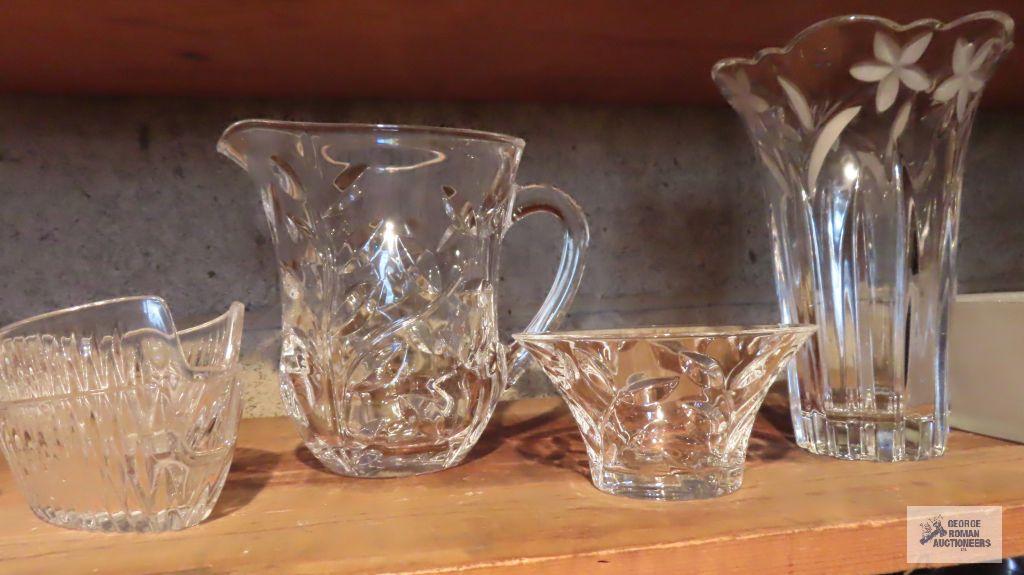 Lot of clear glassware including vases, pitchers, and etc