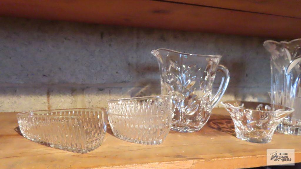 Lot of clear glassware including vases, pitchers, and etc