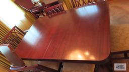 Vintage mahogany dining room table with six chairs and two extra leaves