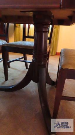 Vintage mahogany dining room table with six chairs and two extra leaves