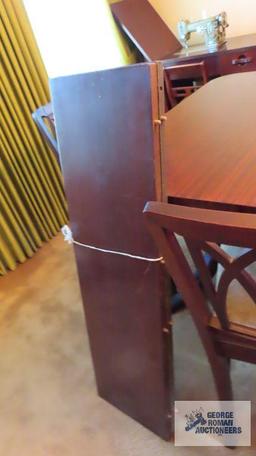 Vintage mahogany dining room table with six chairs and two extra leaves