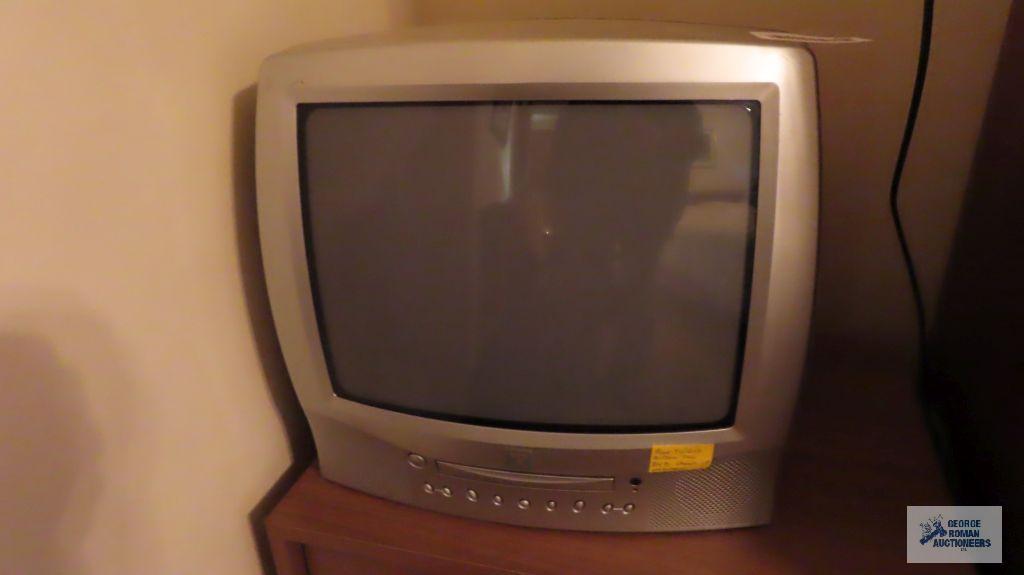 True Tech TV with built-in DVD player, Toshiba TV with built-in DVD player, and wooden nightstand