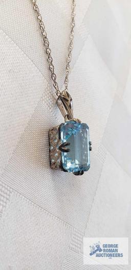 Blue gemstone pendant on silver colored chain, both marked 925