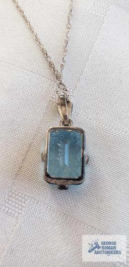 Blue gemstone pendant on silver colored chain, both marked 925