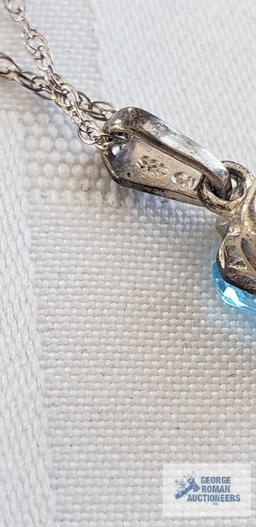 Blue gemstone pendant on silver colored chain, both marked 925