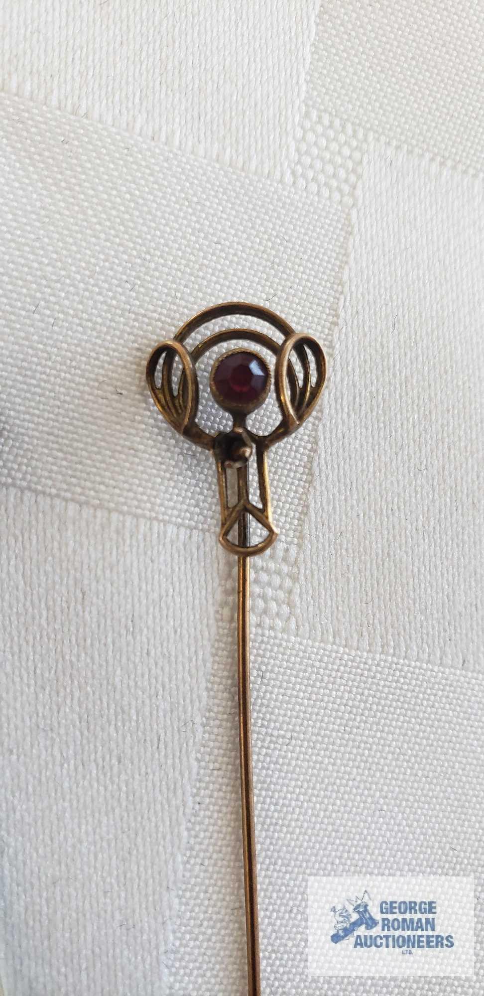 Stick pin with red gemstone, marked 10K and other pin