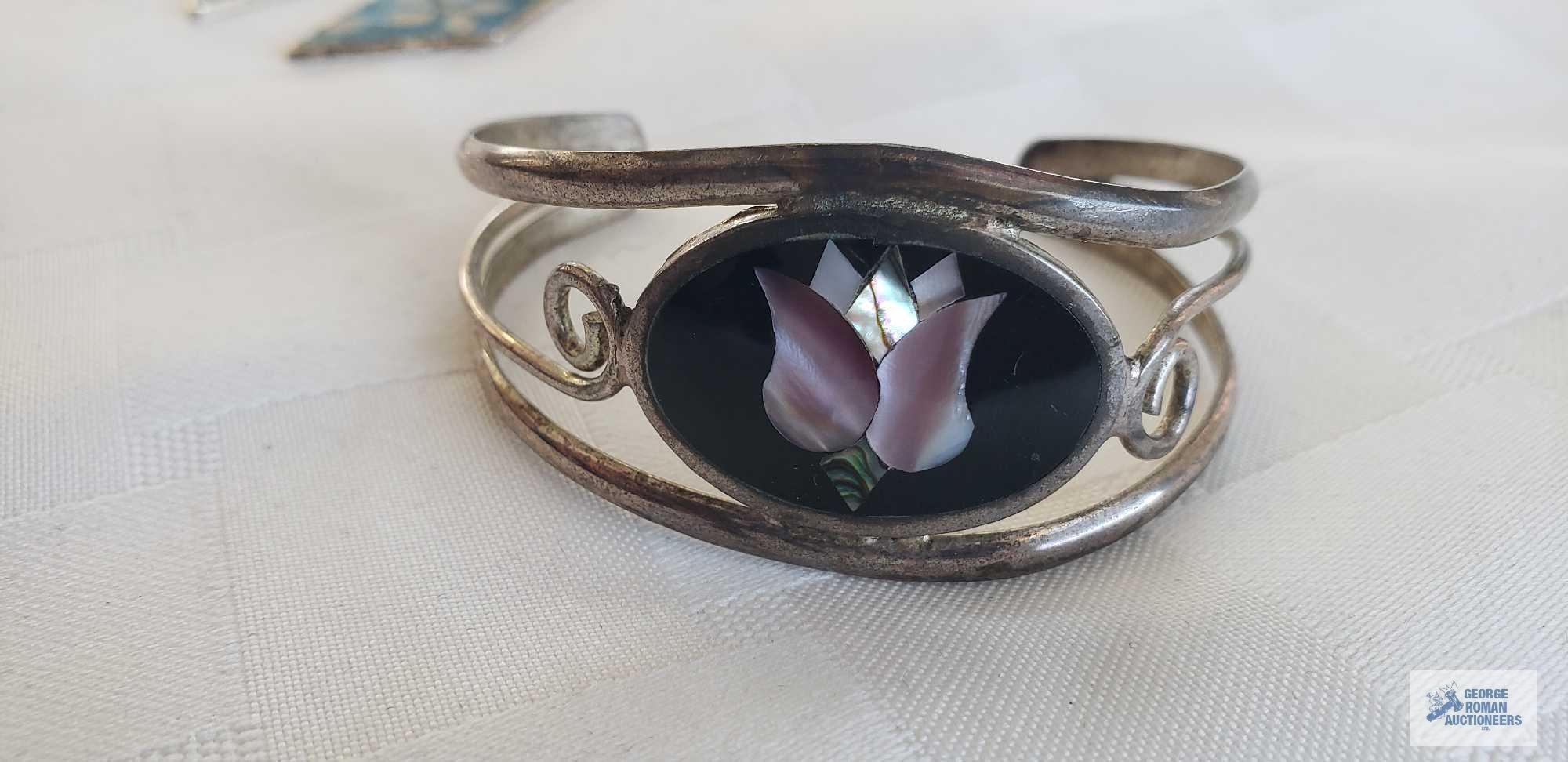 Silver colored cuff bracelet with inlaid flower, marked Mexico....Pair of earrings with turquoise