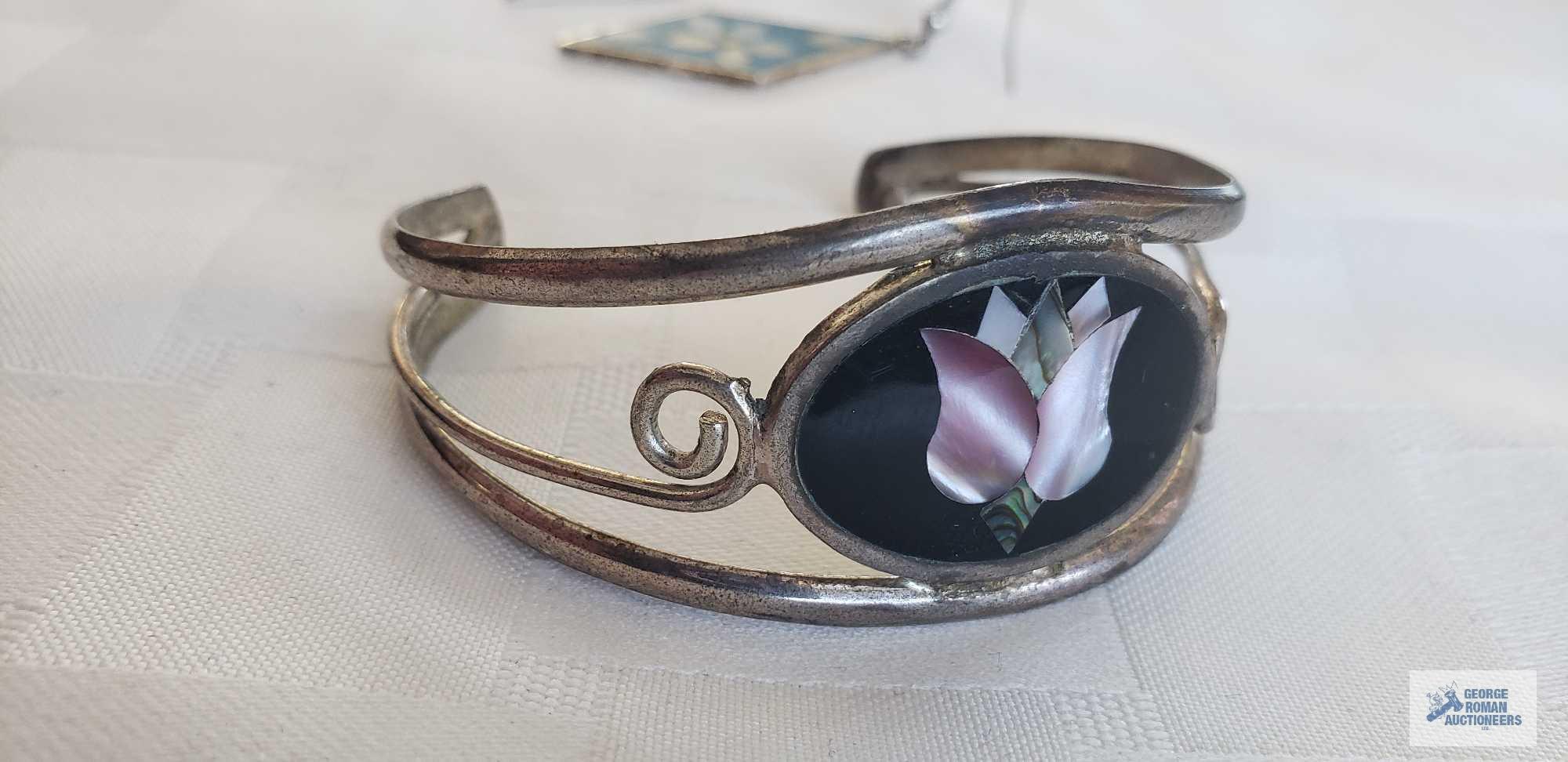 Silver colored cuff bracelet with inlaid flower, marked Mexico....Pair of earrings with turquoise