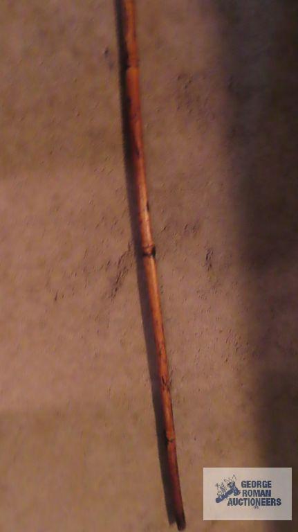 Bamboo like pole spear with hanging elements