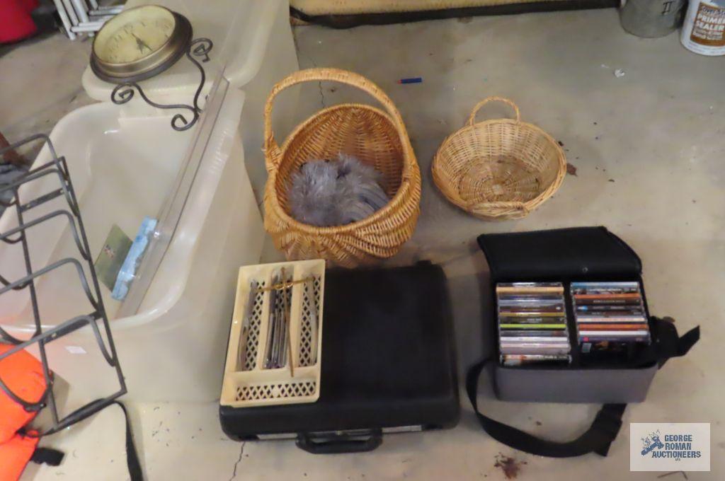 Miscellaneous items including assorted CDs, steak knives, baskets, plastic case, totes, wall clock,
