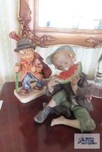 Hummel figurine and boy eating watermelon figurine, both have chips