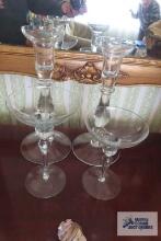 Two sets of clear glass candleholders