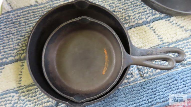 Two small cast iron skillets