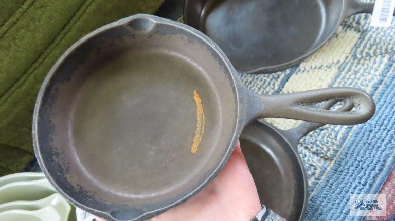 Two small cast iron skillets