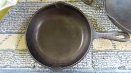 Two small cast iron skillets