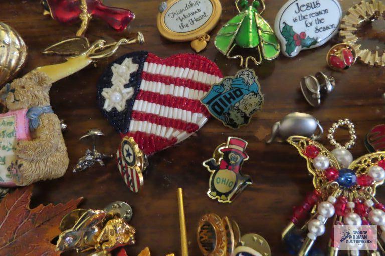 large assortment of pins, earrings,...keychain