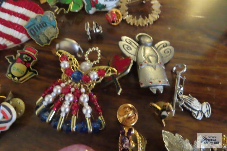 large assortment of pins, earrings,...keychain