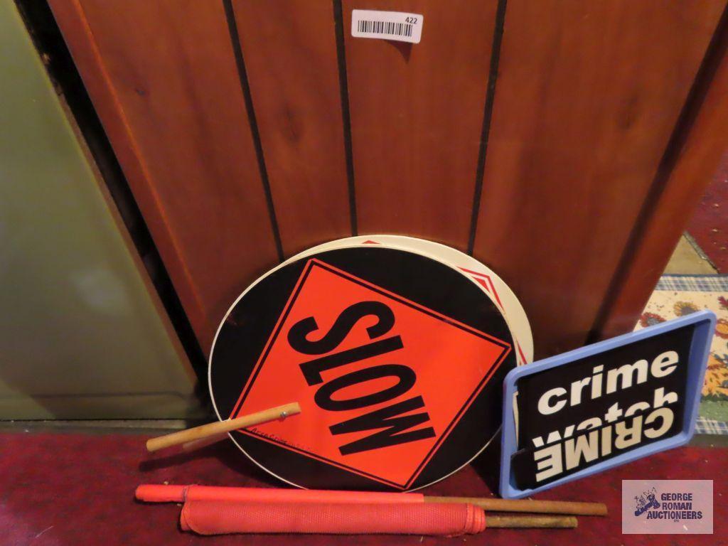 lot of crime watch signs, orange flags and slow / stop signs