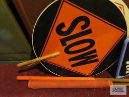 lot of crime watch signs, orange flags and slow / stop signs