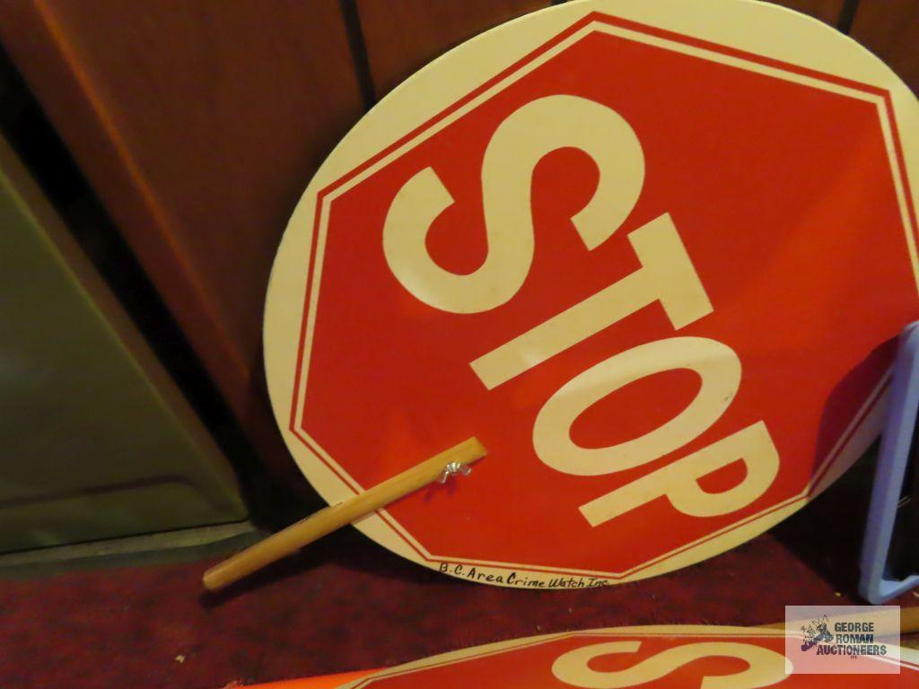 lot of crime watch signs, orange flags and slow / stop signs