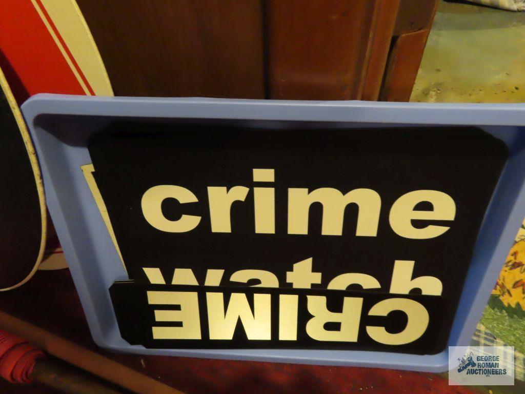 lot of crime watch signs, orange flags and slow / stop signs