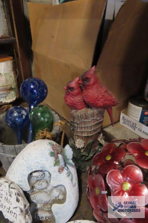 lot of yard decorations, bird feeders, and watering bulbs