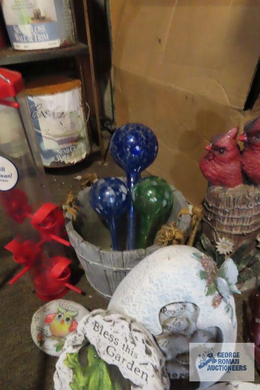 lot of yard decorations, bird feeders, and watering bulbs