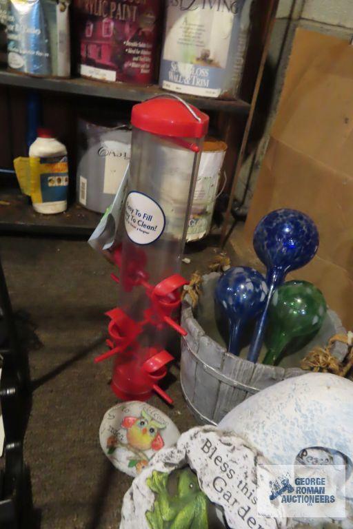 lot of yard decorations, bird feeders, and watering bulbs