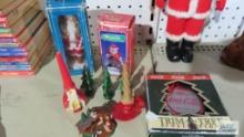 Santa figurines, Coca-Cola ornament, and Christmas candles