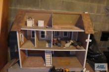 wooden dollhouse in basement