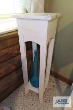 Wooden plant stand with blue glass vase