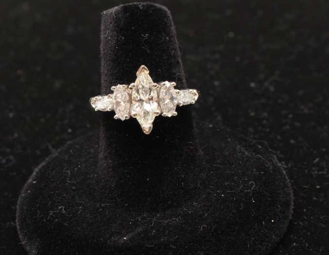 14k white gold ring set with a center marquee diamond