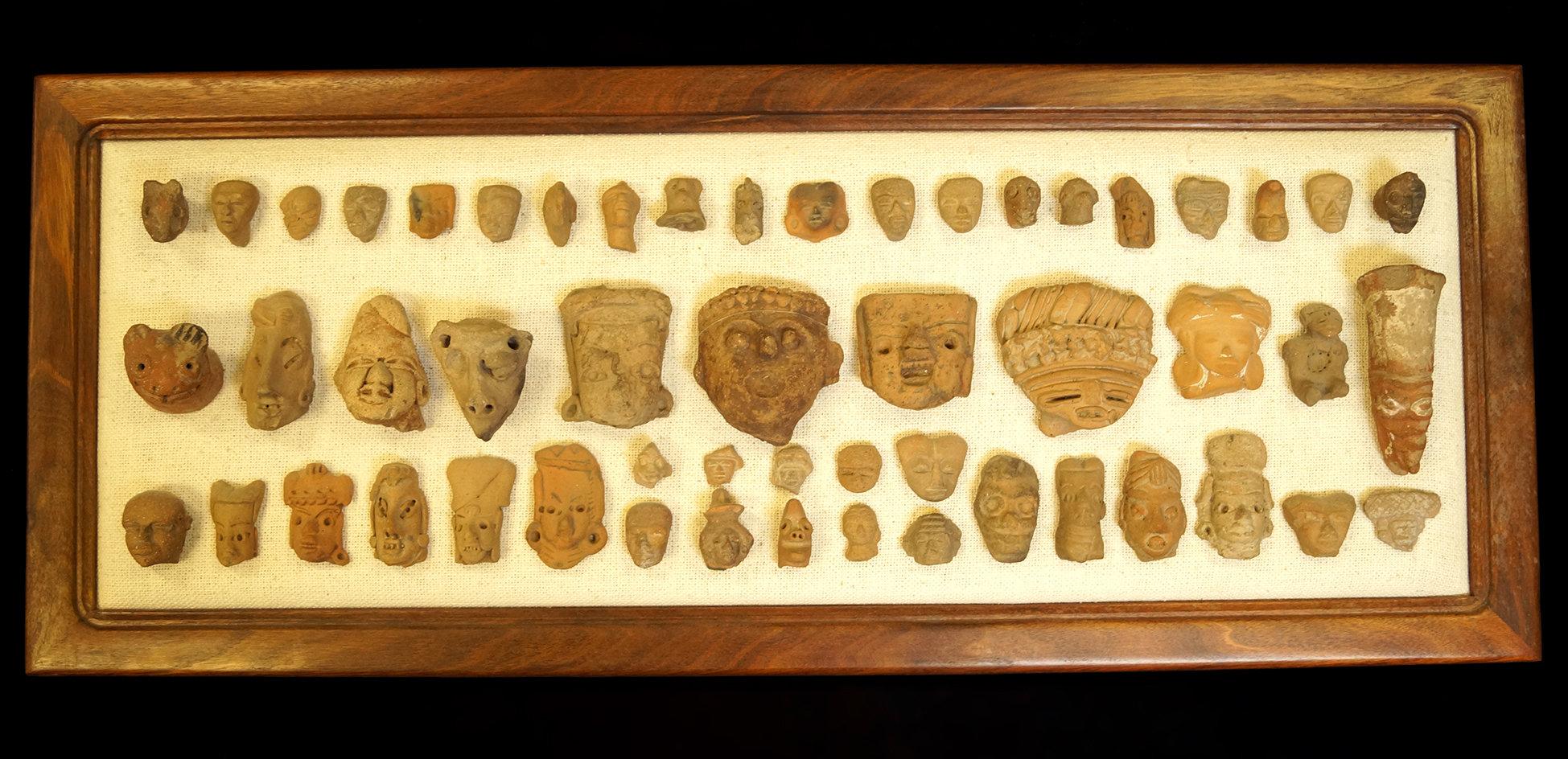 Framed Set of 53 Pre-Columbian Pottery Heads Recovered in Mexico. Largest is 4" x 1 3/4".