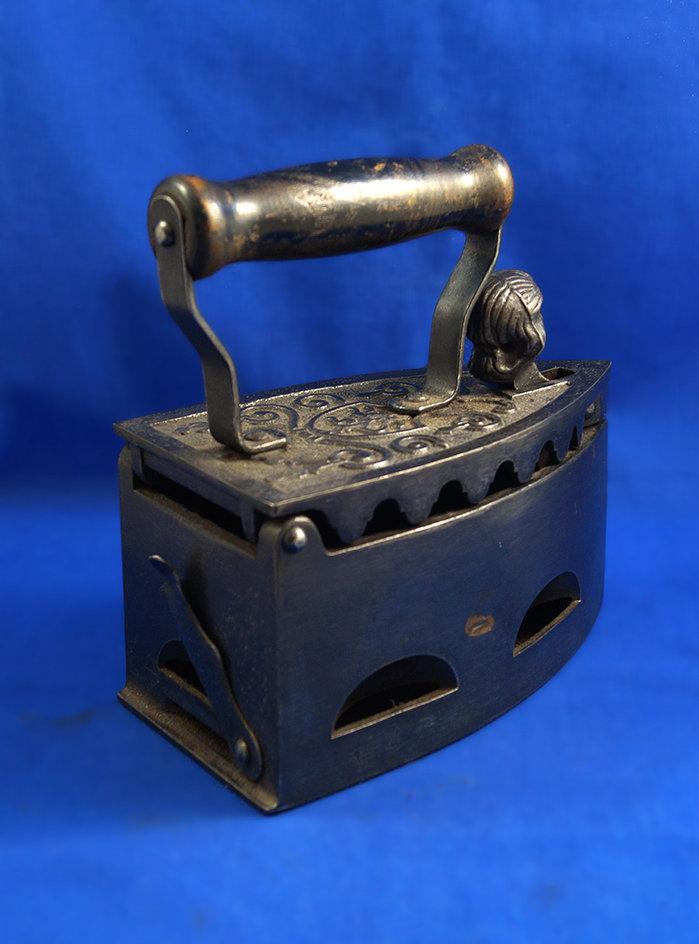 Charcoal iron, cast iron, wood handle, ornate lid, woman's head top latch, Ht 7 1/4", 7 1/4" long